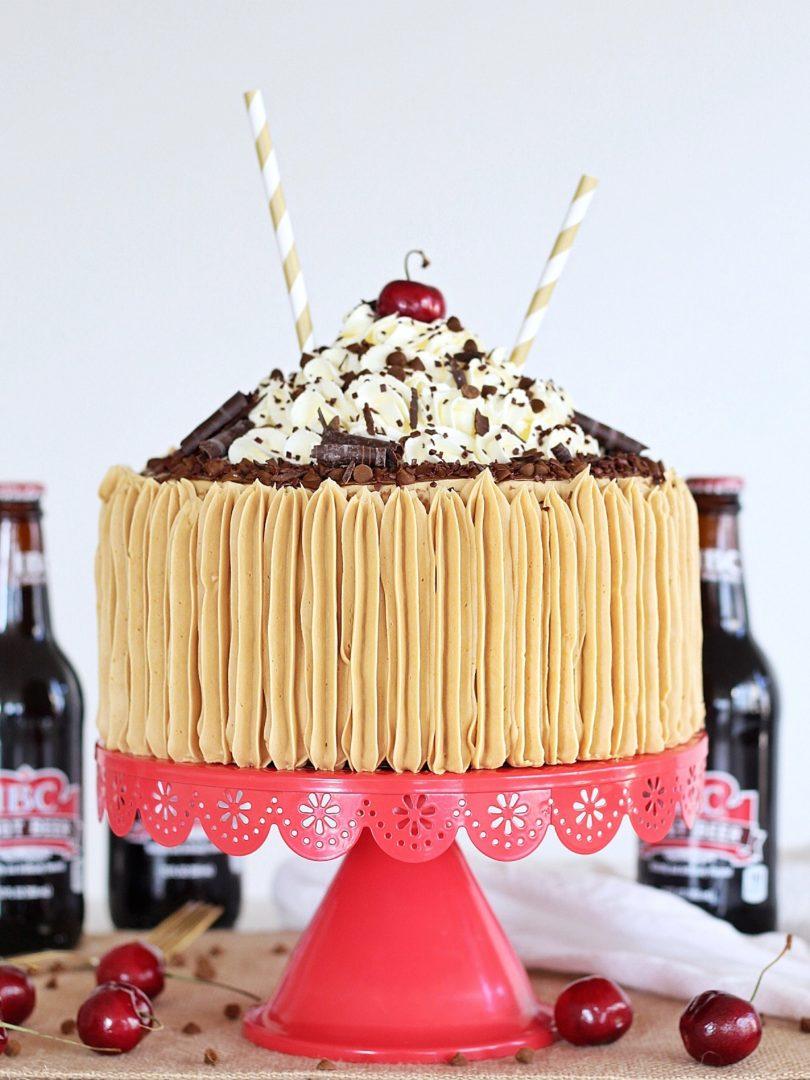 a whole root beer float cake, decorated with frosting and a root beer drizzle