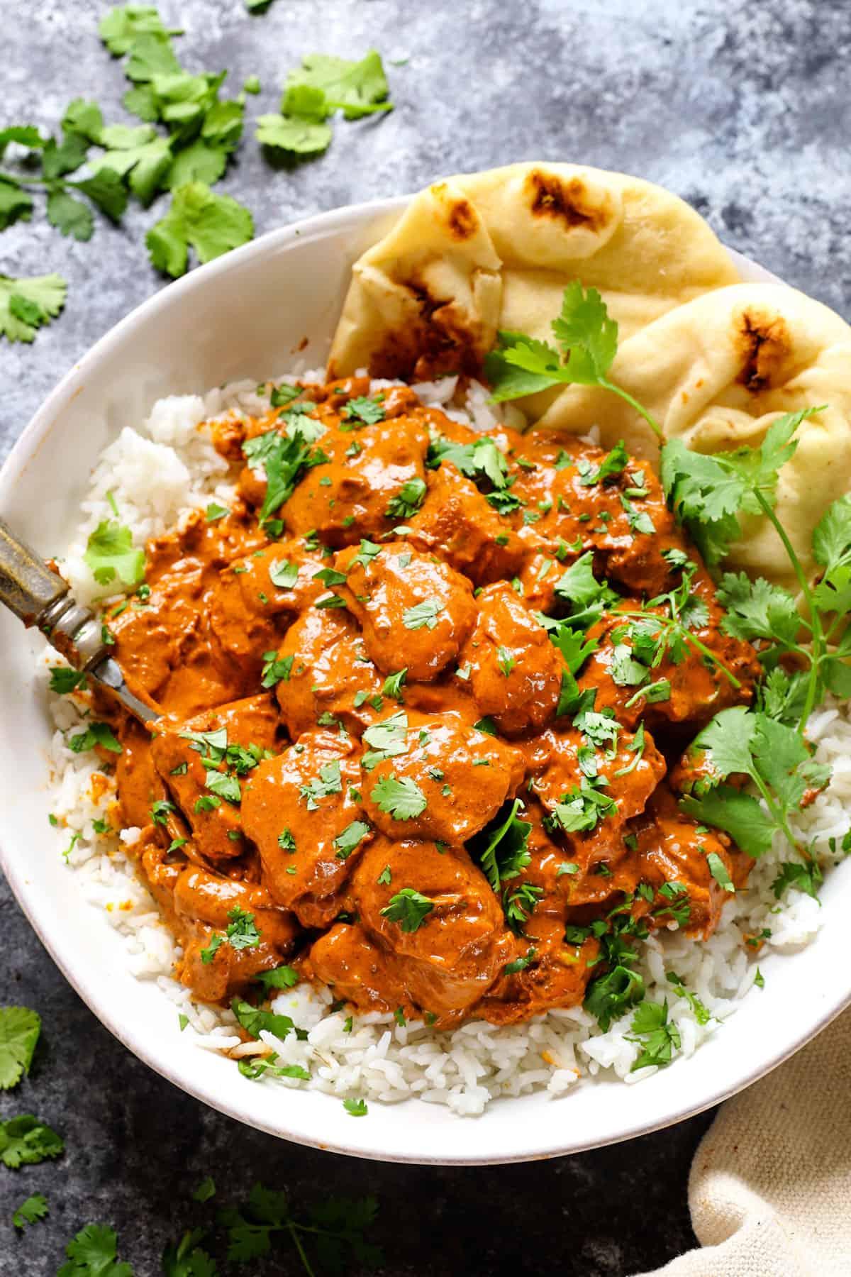 close-up of butter chicken simmering in a pan, showcasing the rich, creamy texture