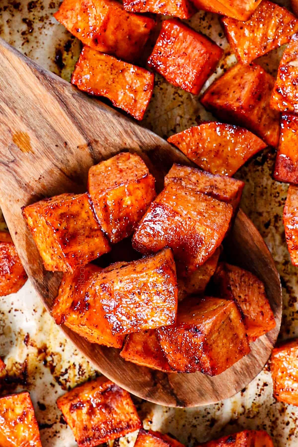 close-up shot of roasted sweet potato chunks with pronounced caramelization and glistening edges, rich orange color