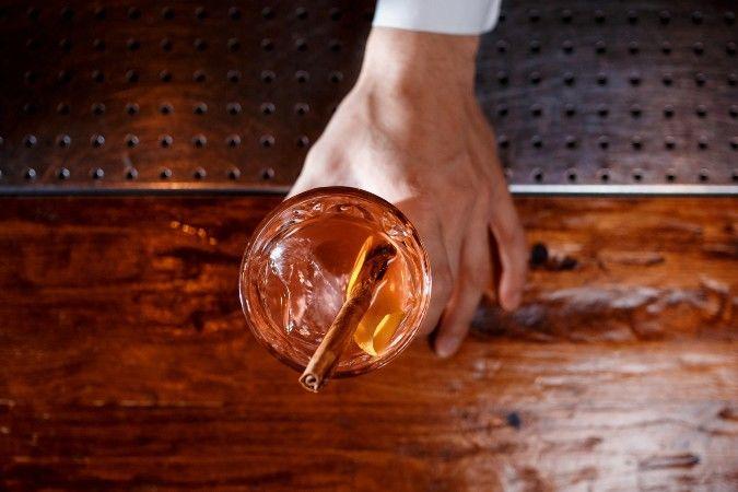 Close-up shot of spiced rum being poured into a marinade