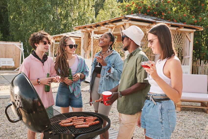 backyard barbecue party with friends grilling