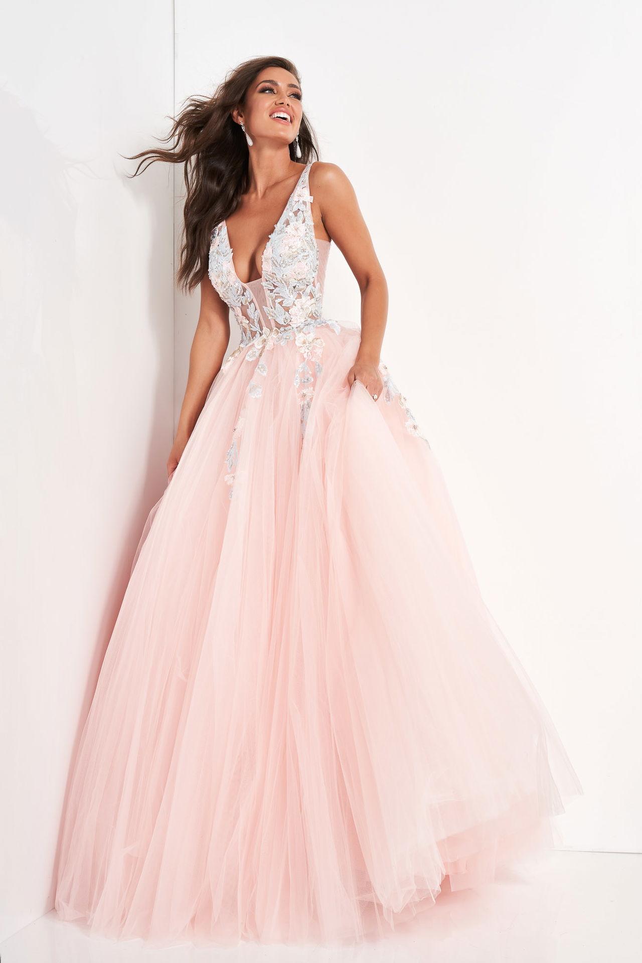 Model wearing a luxurious blush pink prom dress with silver embroidery