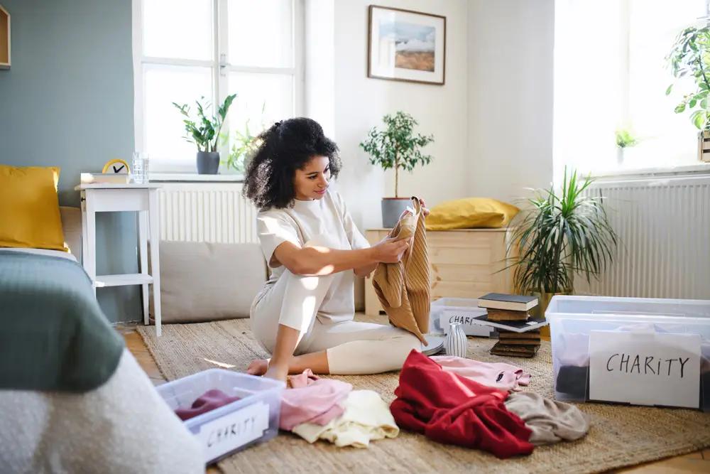 person decluttering bedroom
