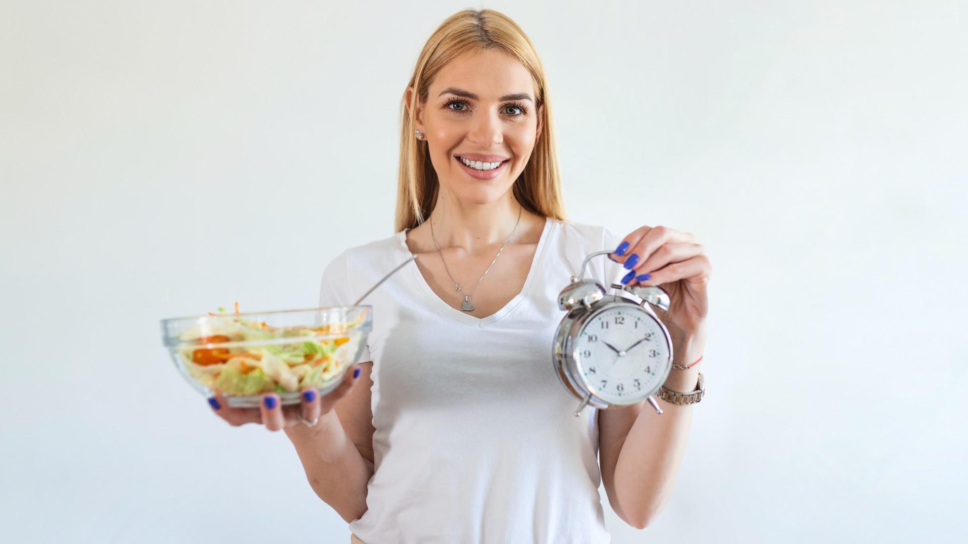 woman enjoying a healthy dinner while intermittent fasting