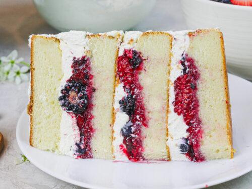 close-up shot of a slice of vanilla birthday cake with goji berry compote