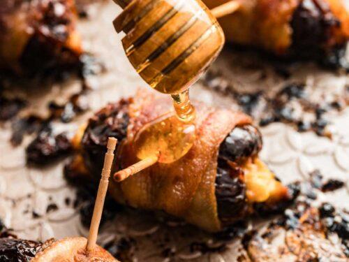 Platter of freshly baked bacon-wrapped dates, golden brown and glistening