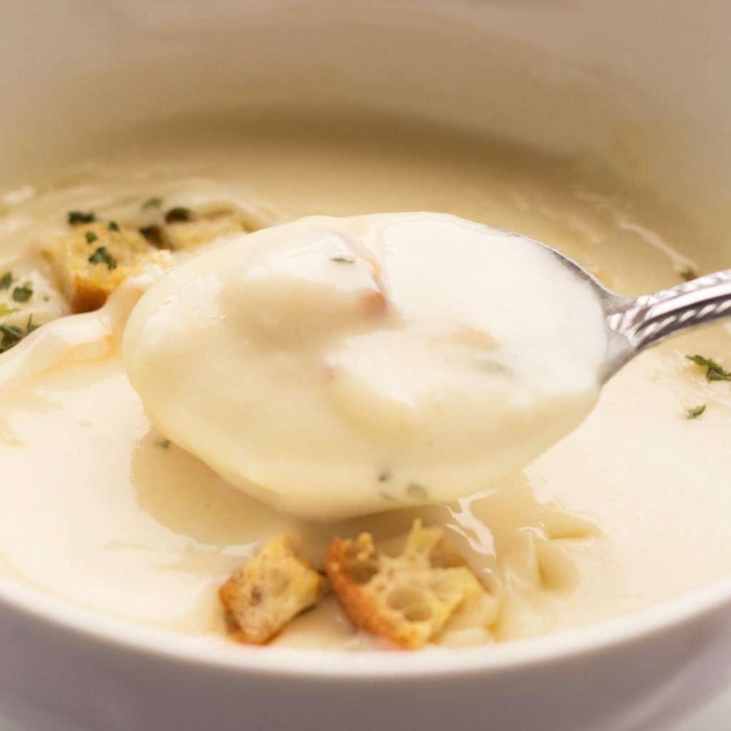 close-up shot of a spoonful of creamy potato soup