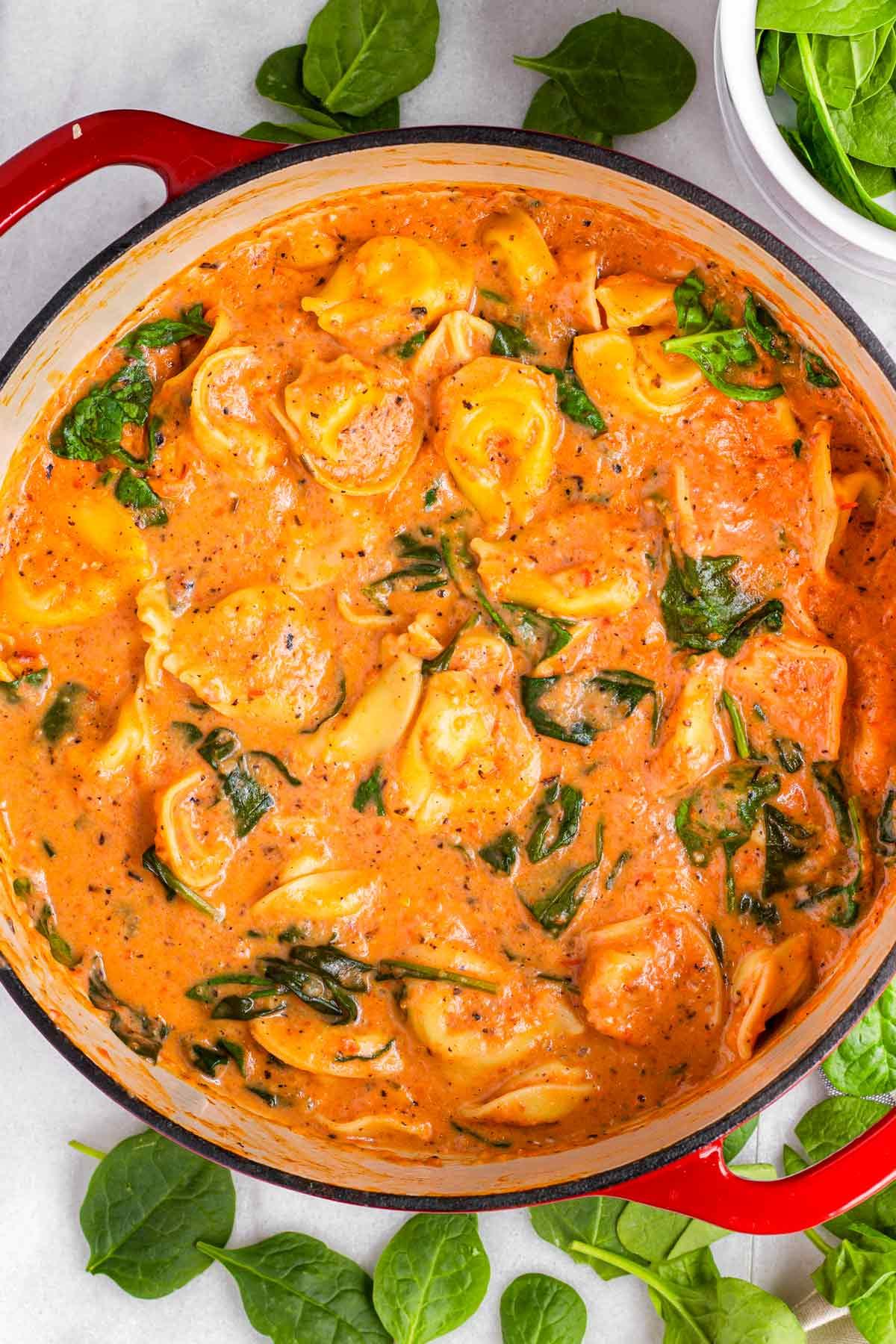 ingredients for creamy tomato tortellini soup laid out on a kitchen counter