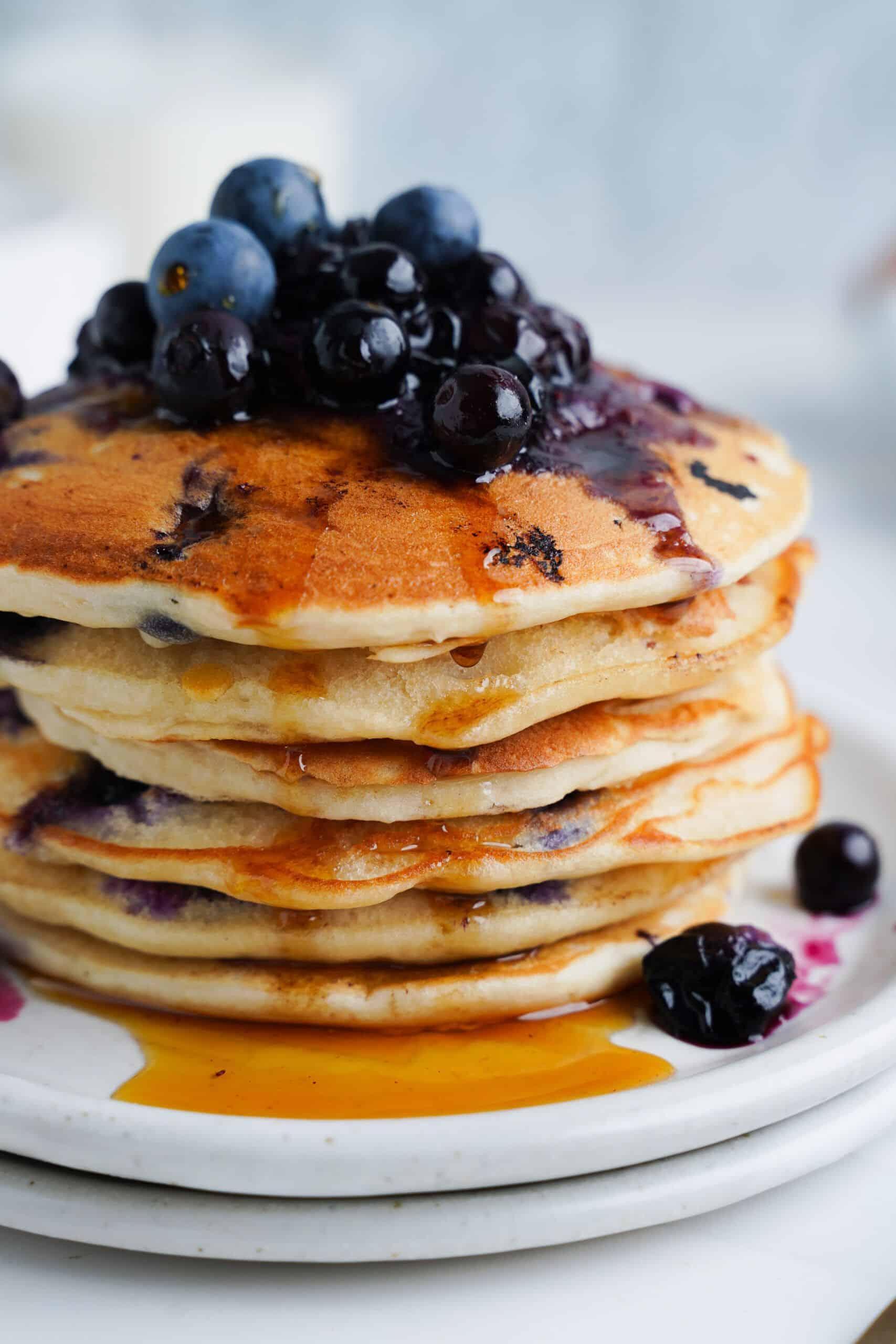 Close-up of blueberries being folded into pancake batter
