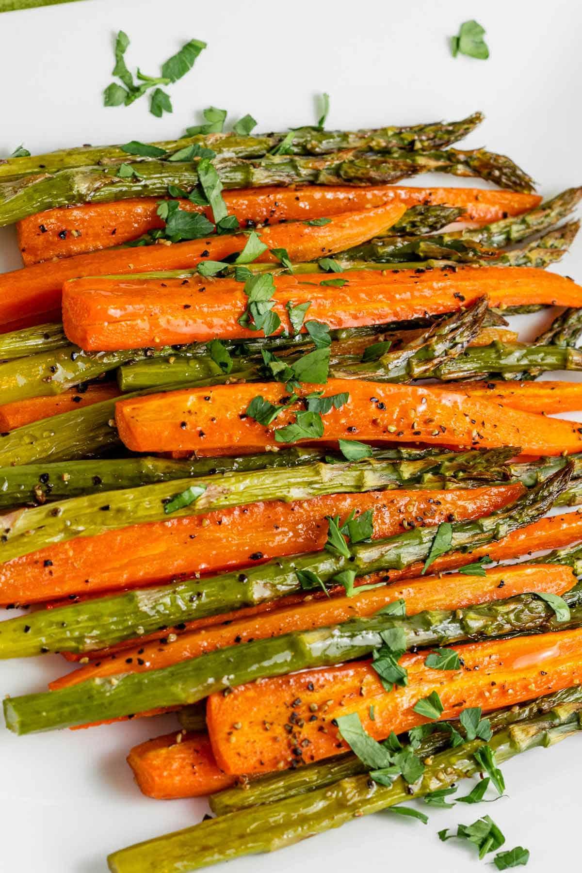 table with both glazed carrots and roasted asparagus
