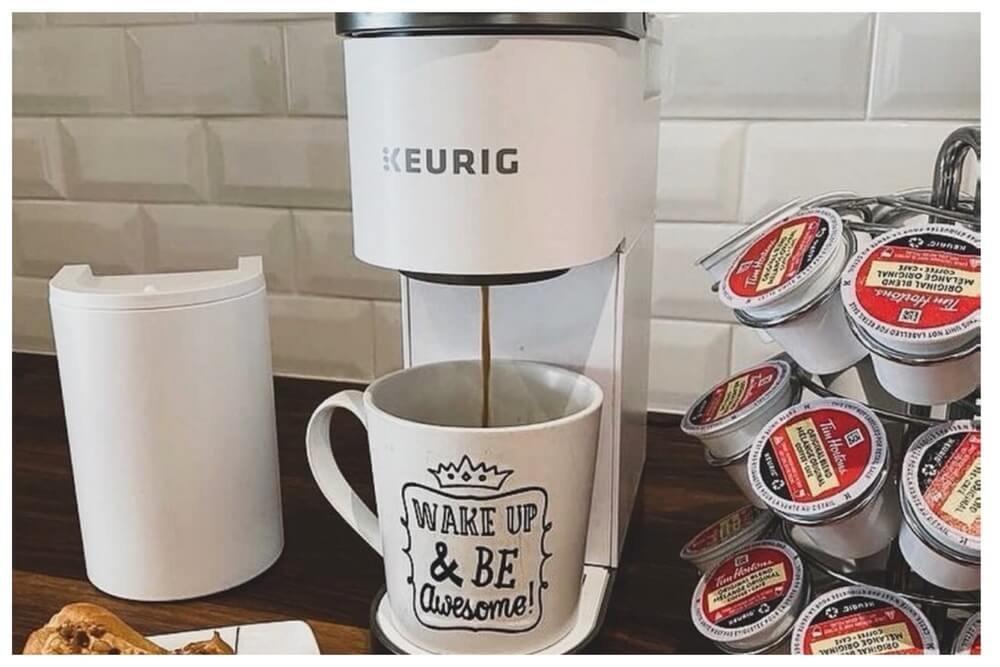 Close-up of a Keurig K-Mini Plus brewing a cup of coffee