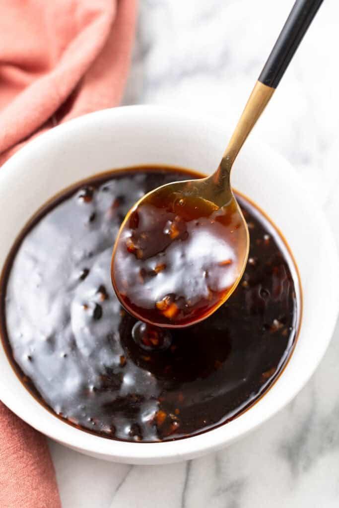 Vibrant close-up of honey garlic sauce being whisked in a bowl