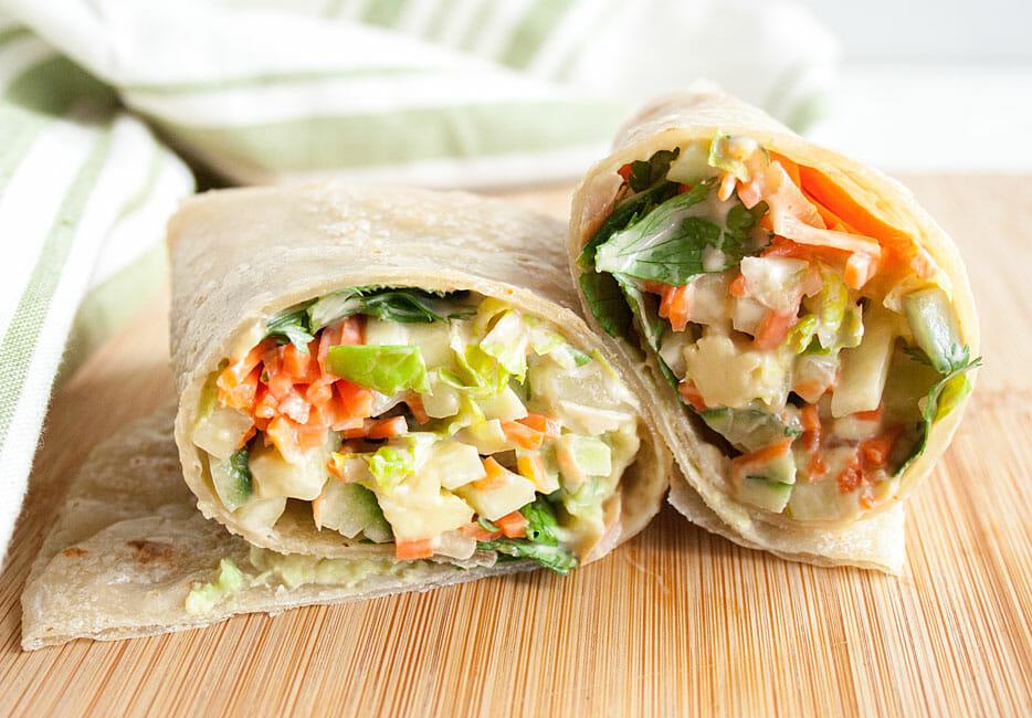 close-up shot of a summer veggie wrap being assembled
