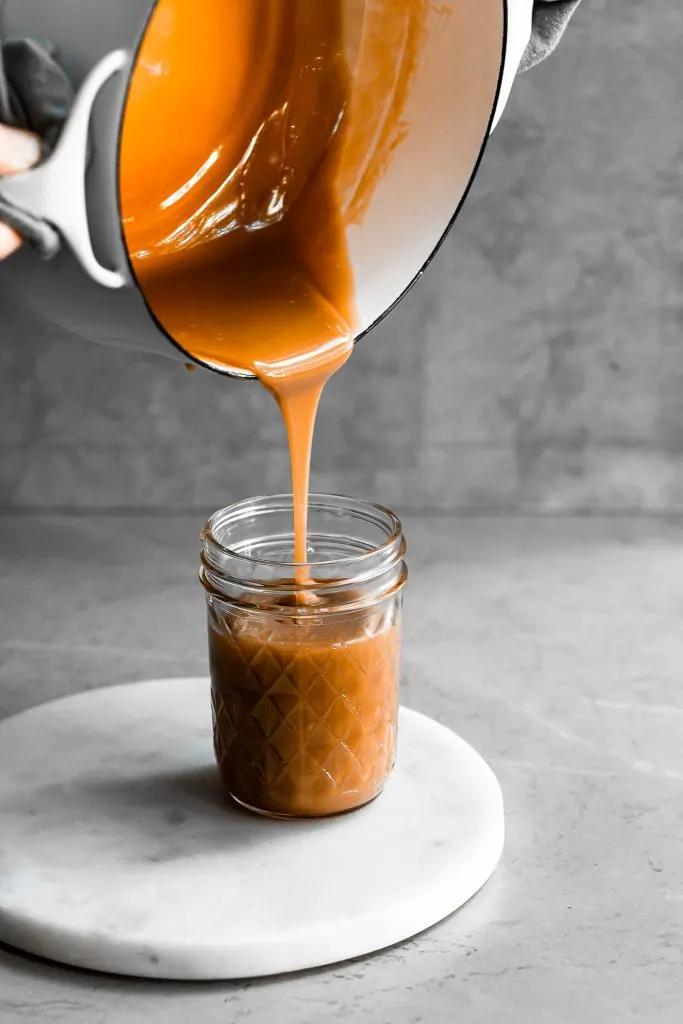 Close-up of a creamy Cookie Dough Lassi being poured into a glass