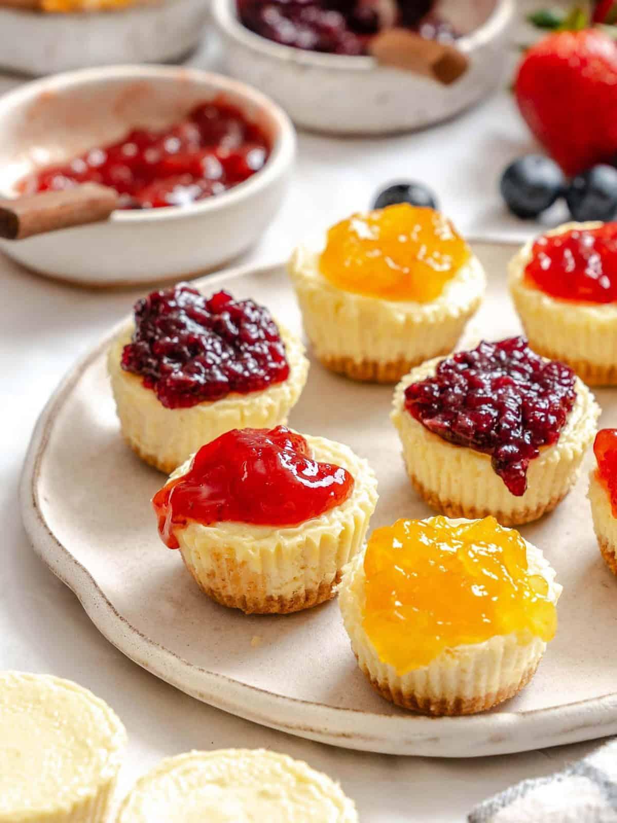 Mini cheese tarts cooling on a rack, some with a bite taken out