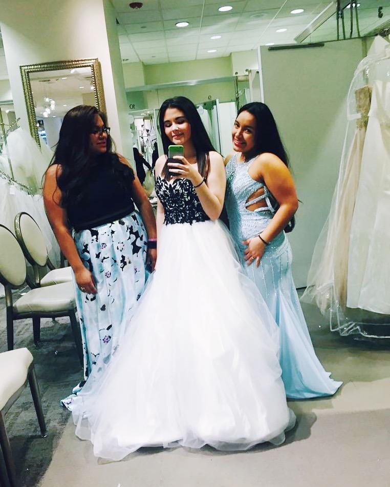 woman trying on prom dresses