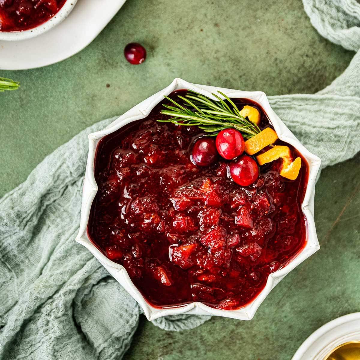 Family enjoying a holiday meal with a bowl of homemade cranberry sauce centerpiece