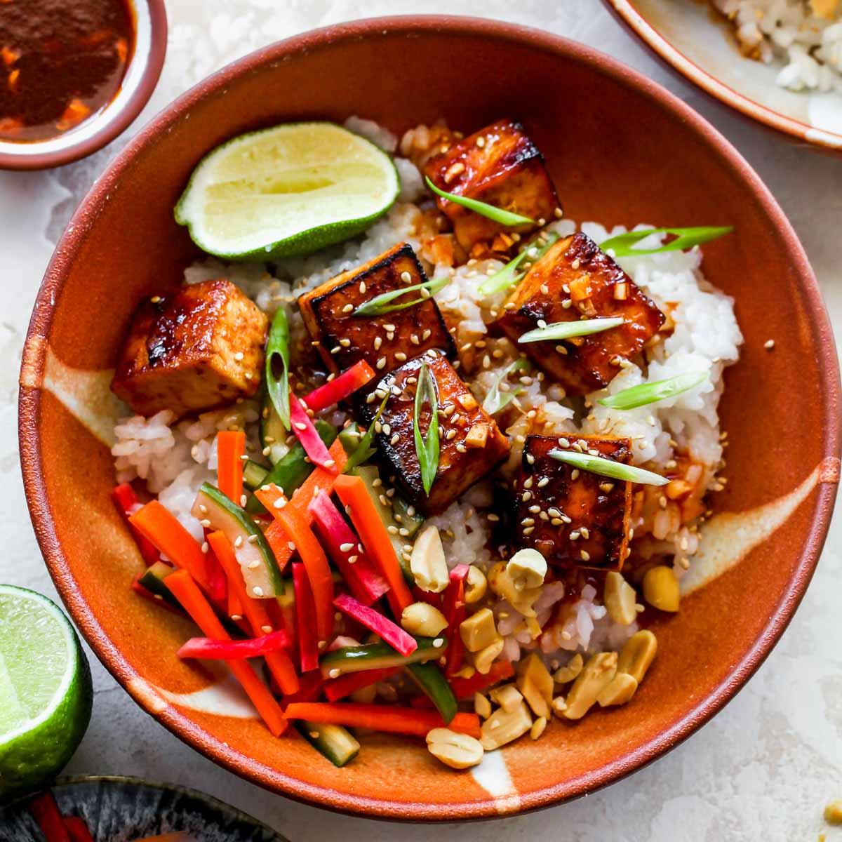 a serving bowl filled with spicy gochujang tofu and rice