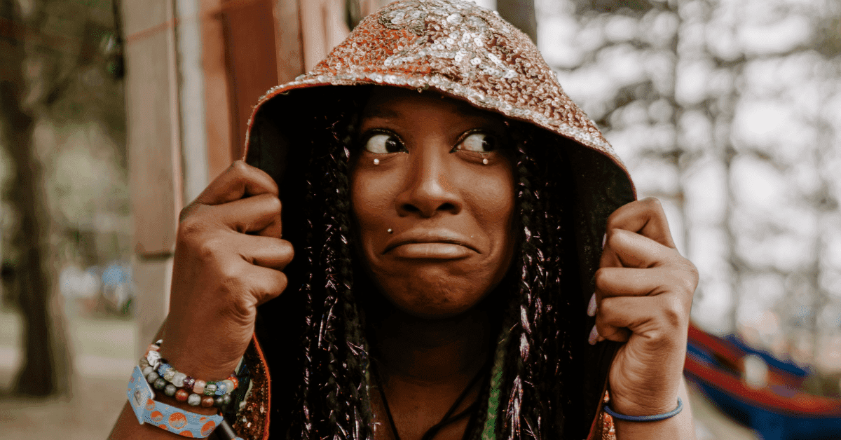 person looking stressed while trying to take a picture at a festival