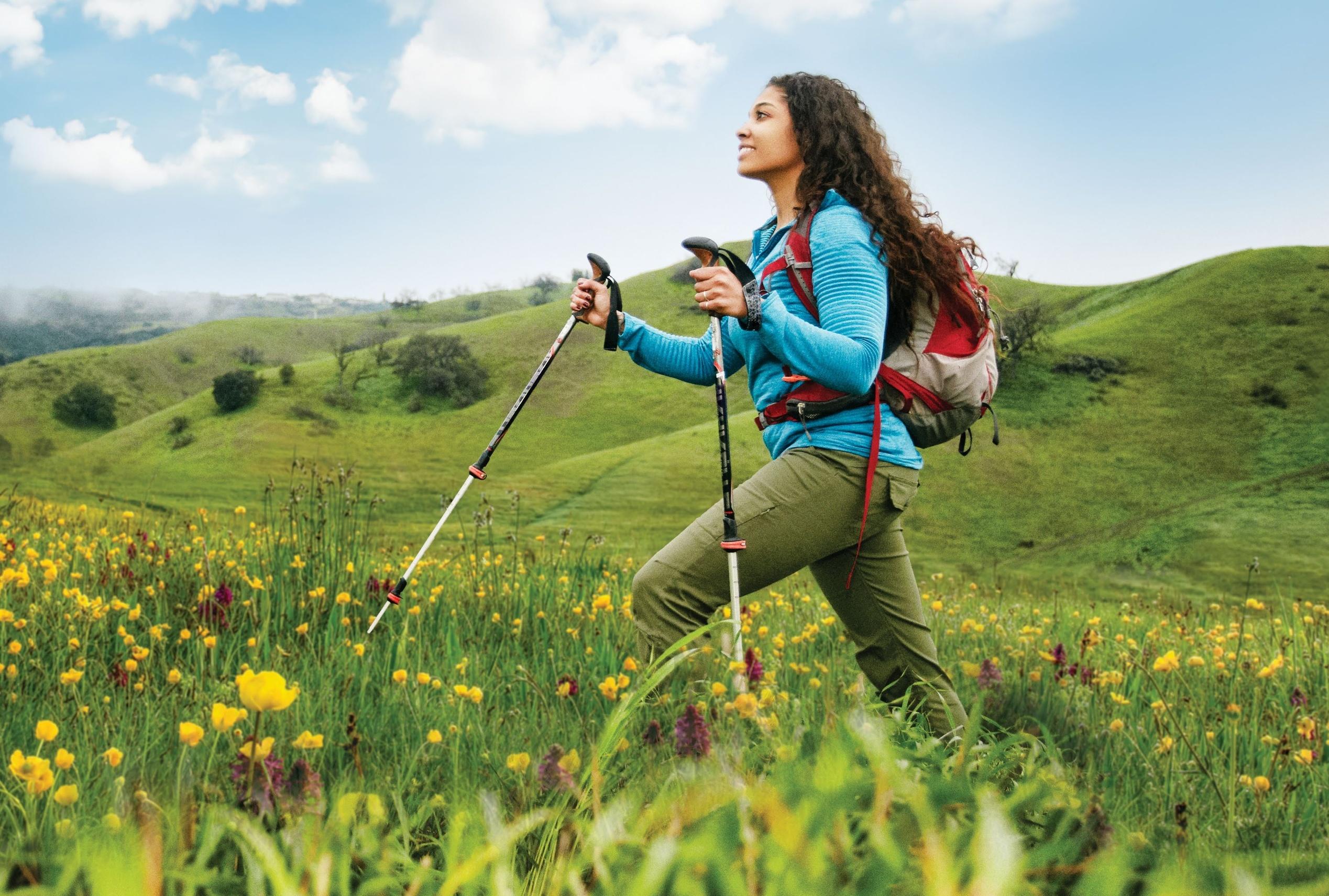 woman hiking with poles in spring