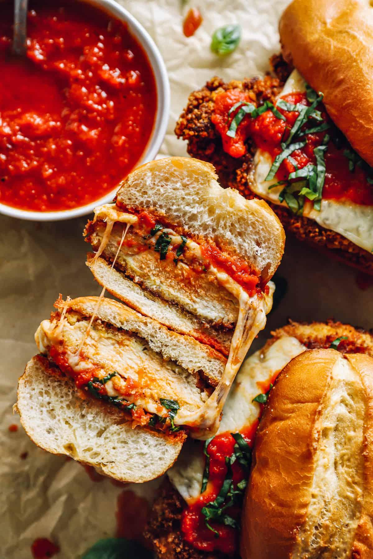 ingredients for chicken parmesan club sandwich displayed on a wooden table