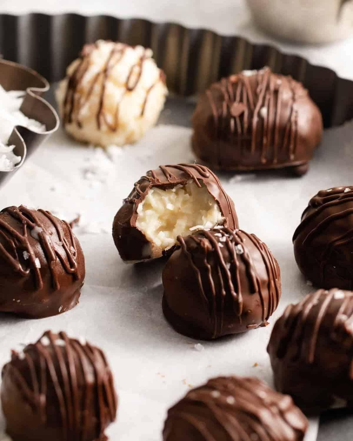 top-down shot of several finished coconut truffles arranged artfully on a cooling rack