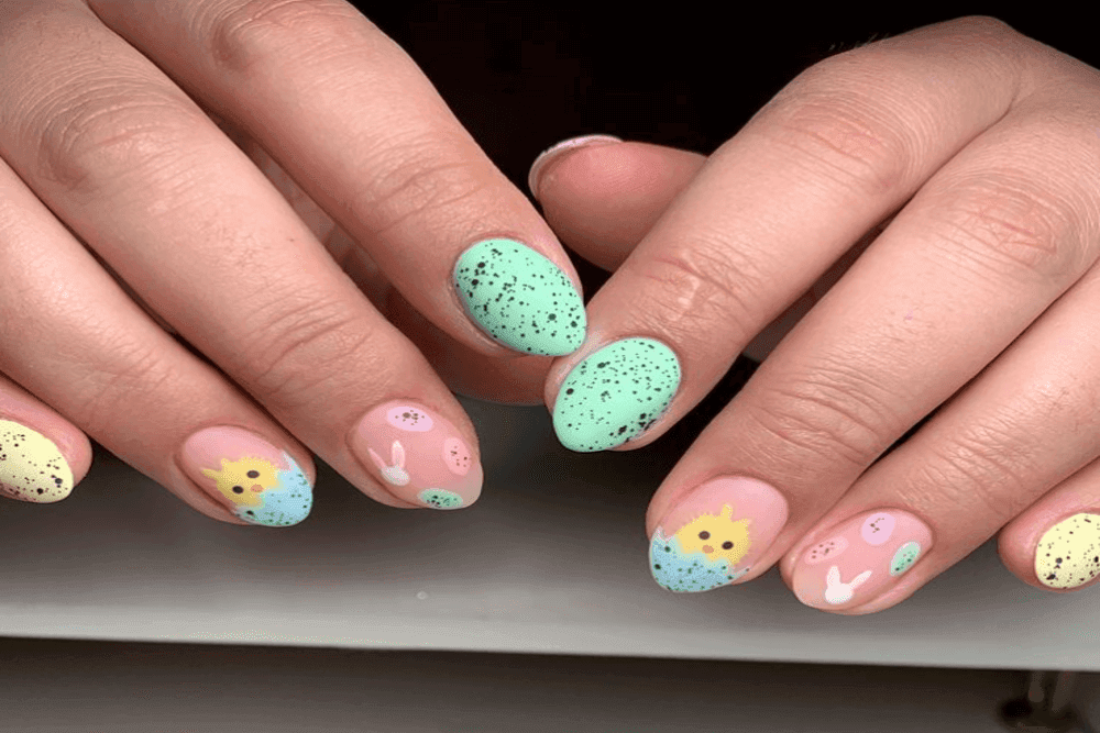 Nail art design featuring hidden Easter eggs in a floral pattern