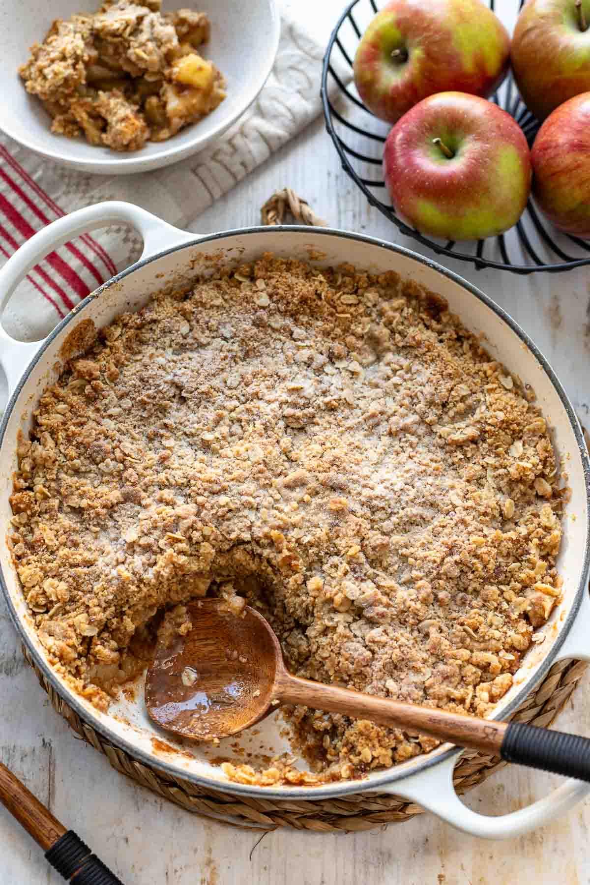 Grandma baking apple crumble in a cozy kitchen, warm lighting