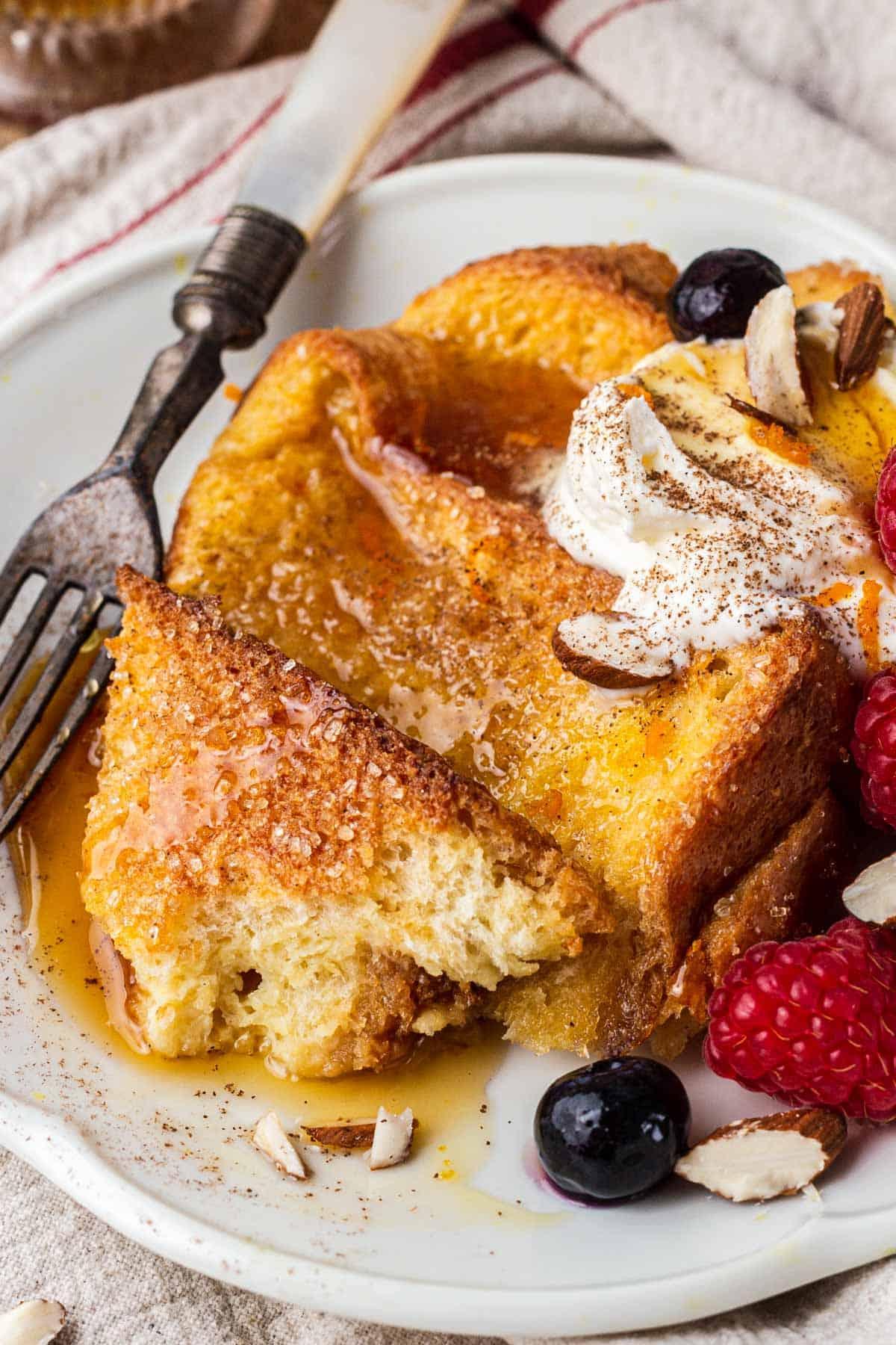 close-up shot of a delicious-looking slice of French toast casserole being lifted from a baking dish