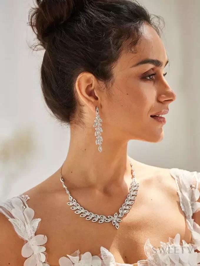 woman wearing elegant chandelier earrings at a formal event