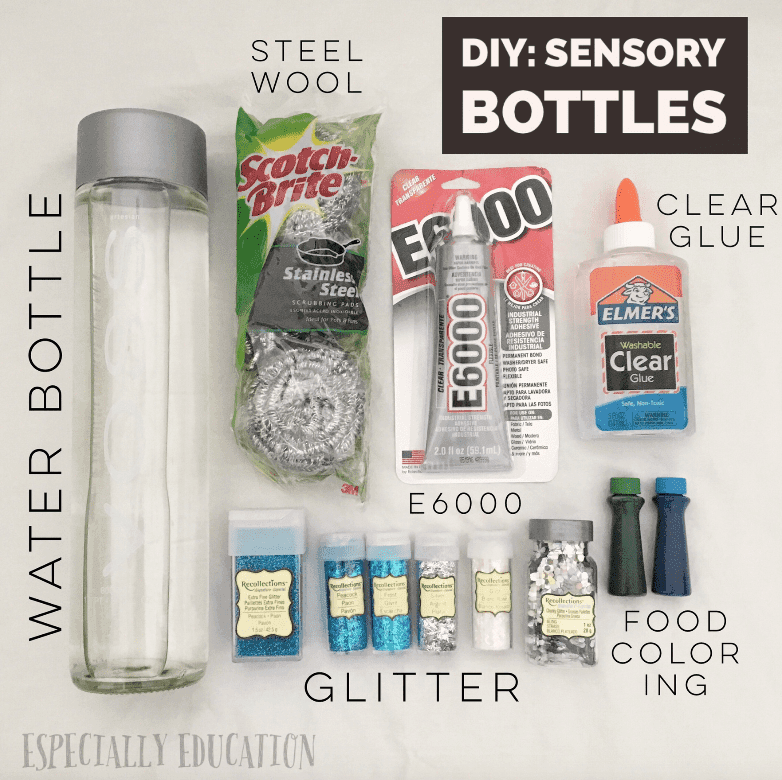 A table with various crafting materials for making a sensory bottle