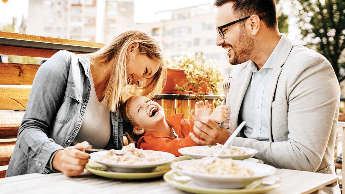 happy family eating dinner together