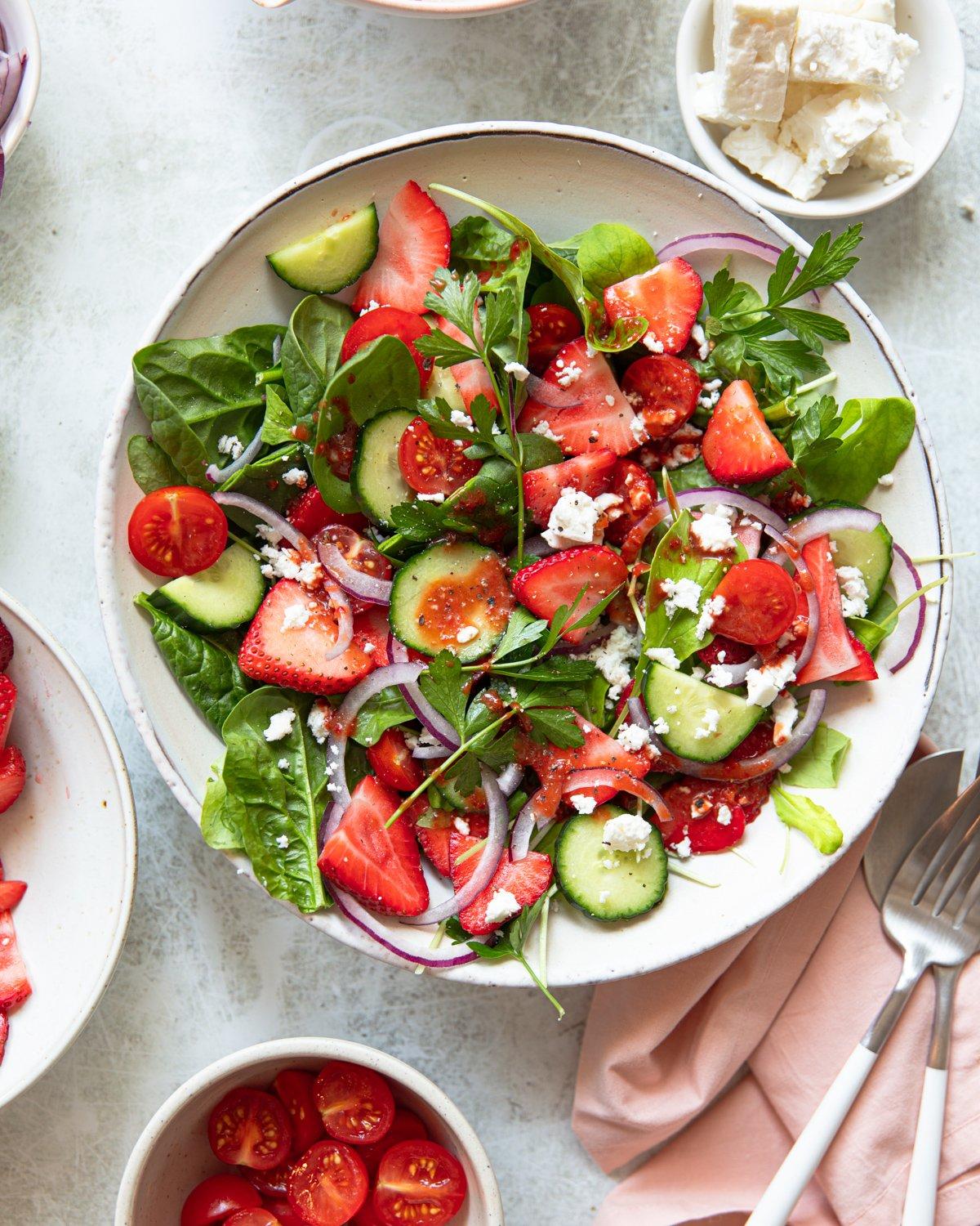 close-up of strawberry feta salad with balsamic glaze drizzled on top