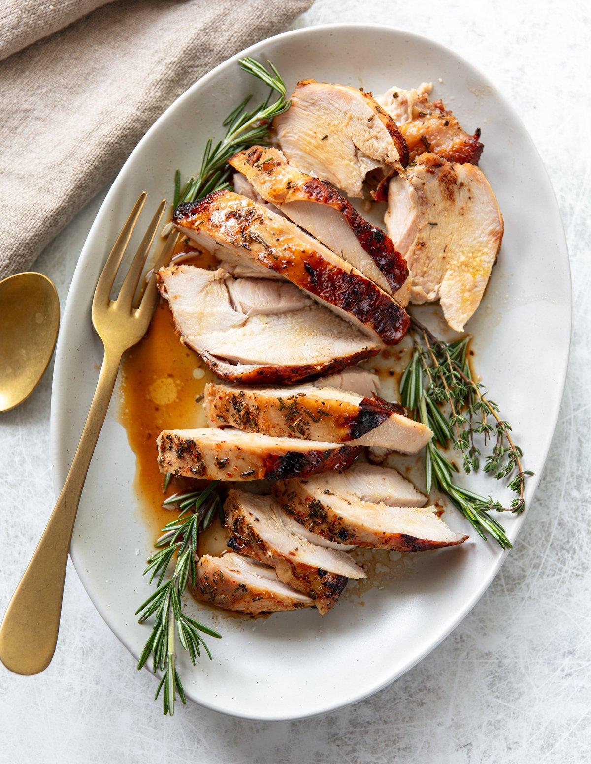 Close-up of a perfectly golden-brown pan-seared turkey breast on a cutting board