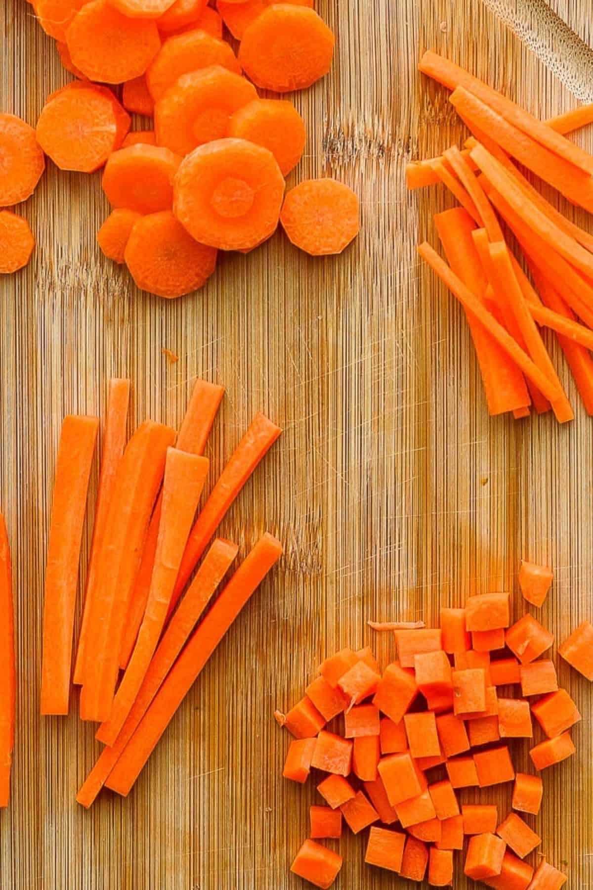 Close-up of raw carrots being sliced into fry shapes