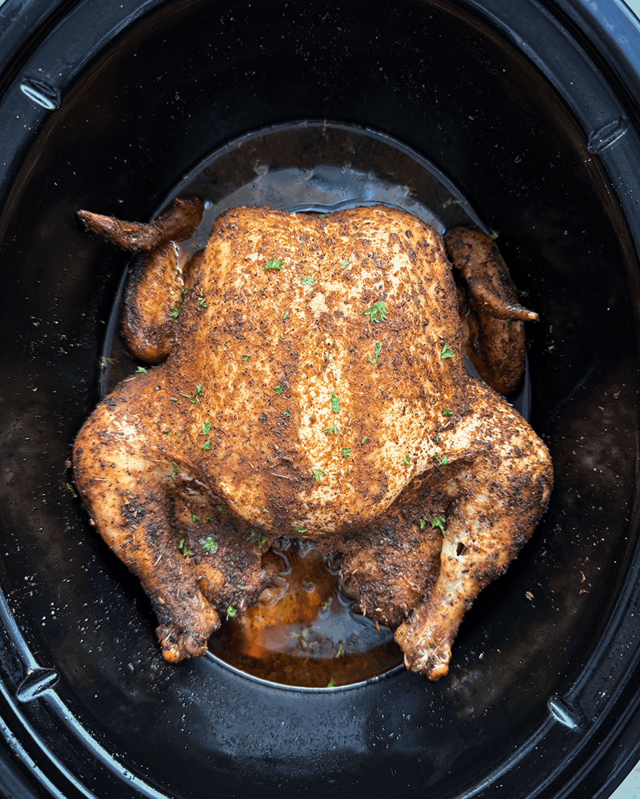 close-up shot of cooked crockpot chicken in the slow cooker