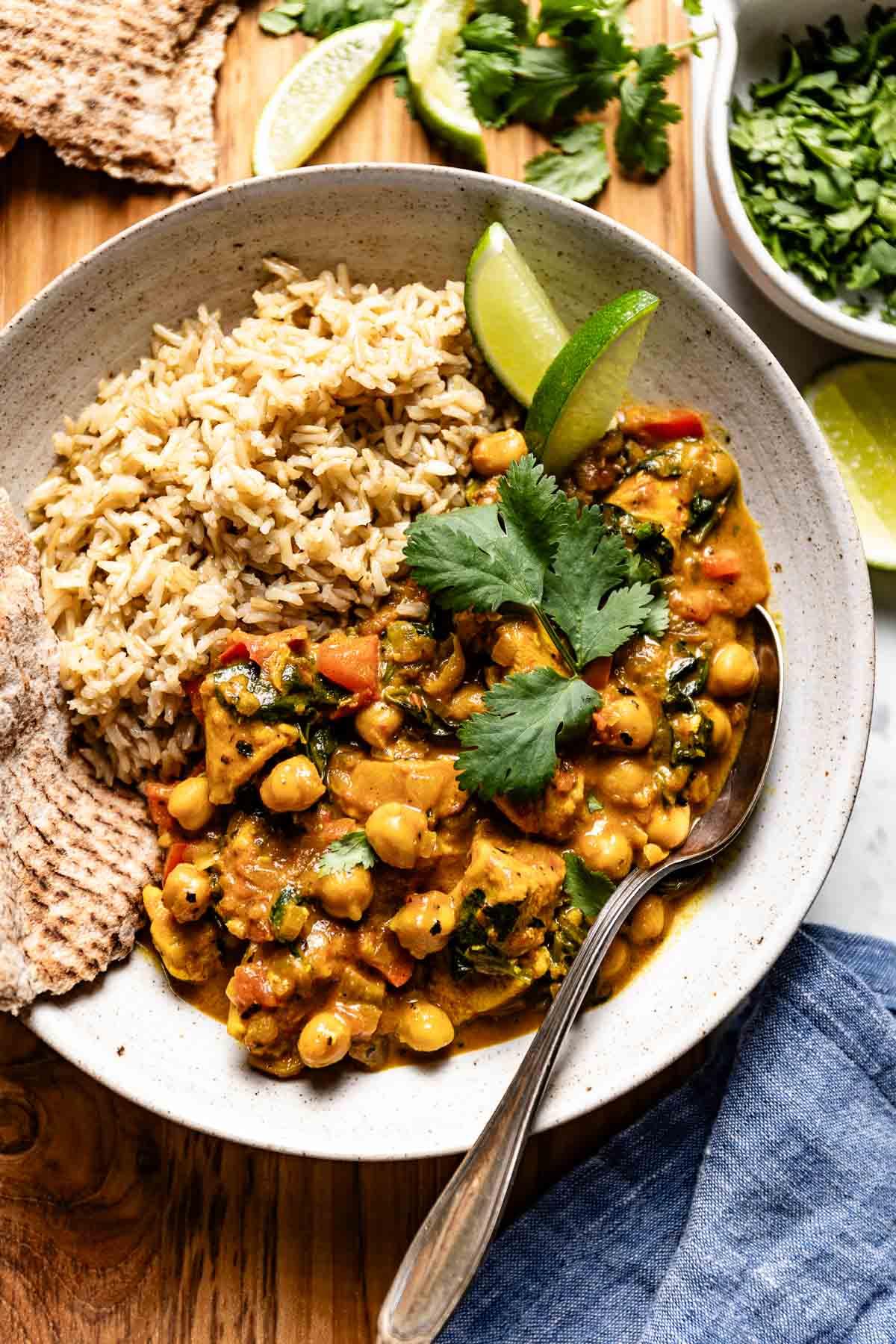 a person serving a bowl of chickpea curry