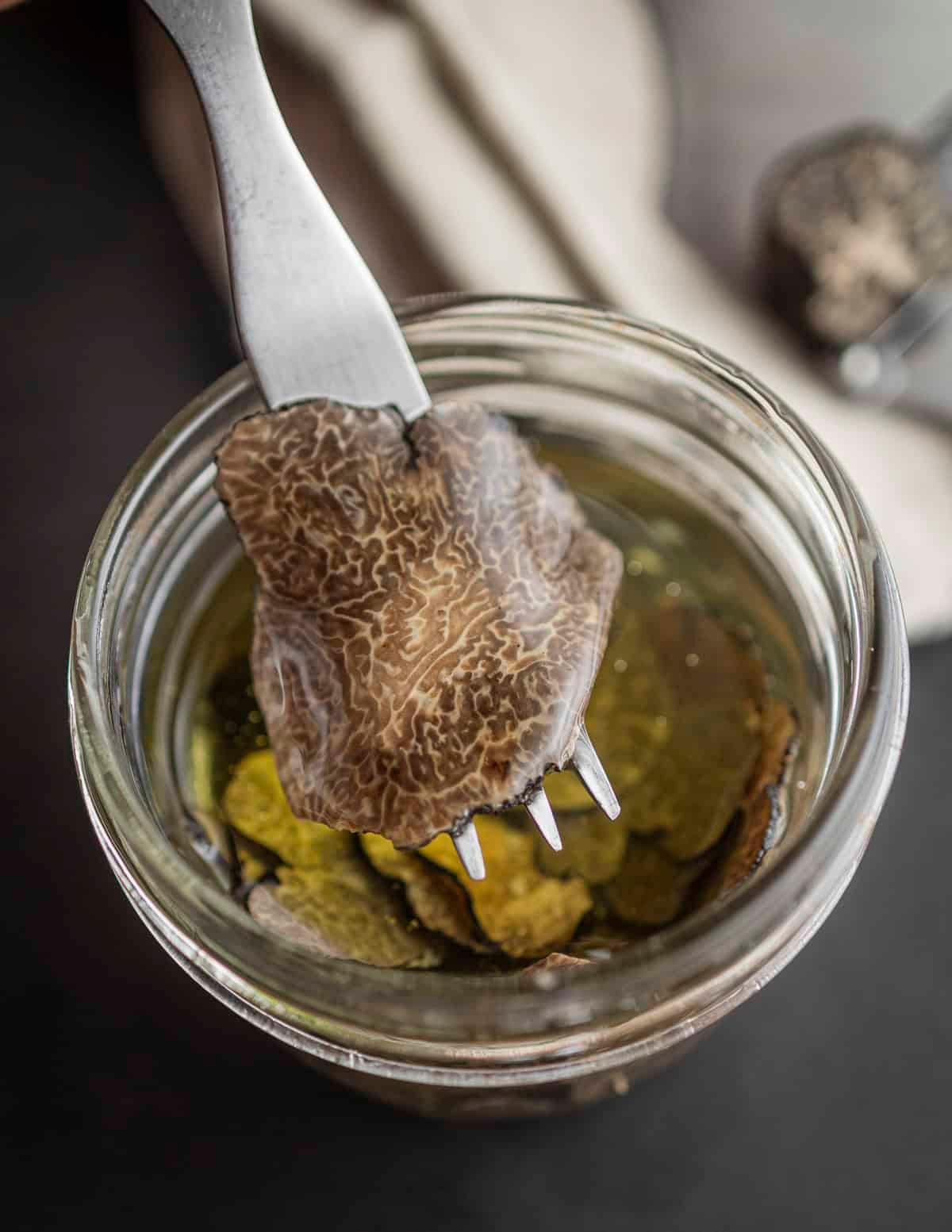 Close-up shot of a slice of Truffle Infused Caprese being lifted with a fork