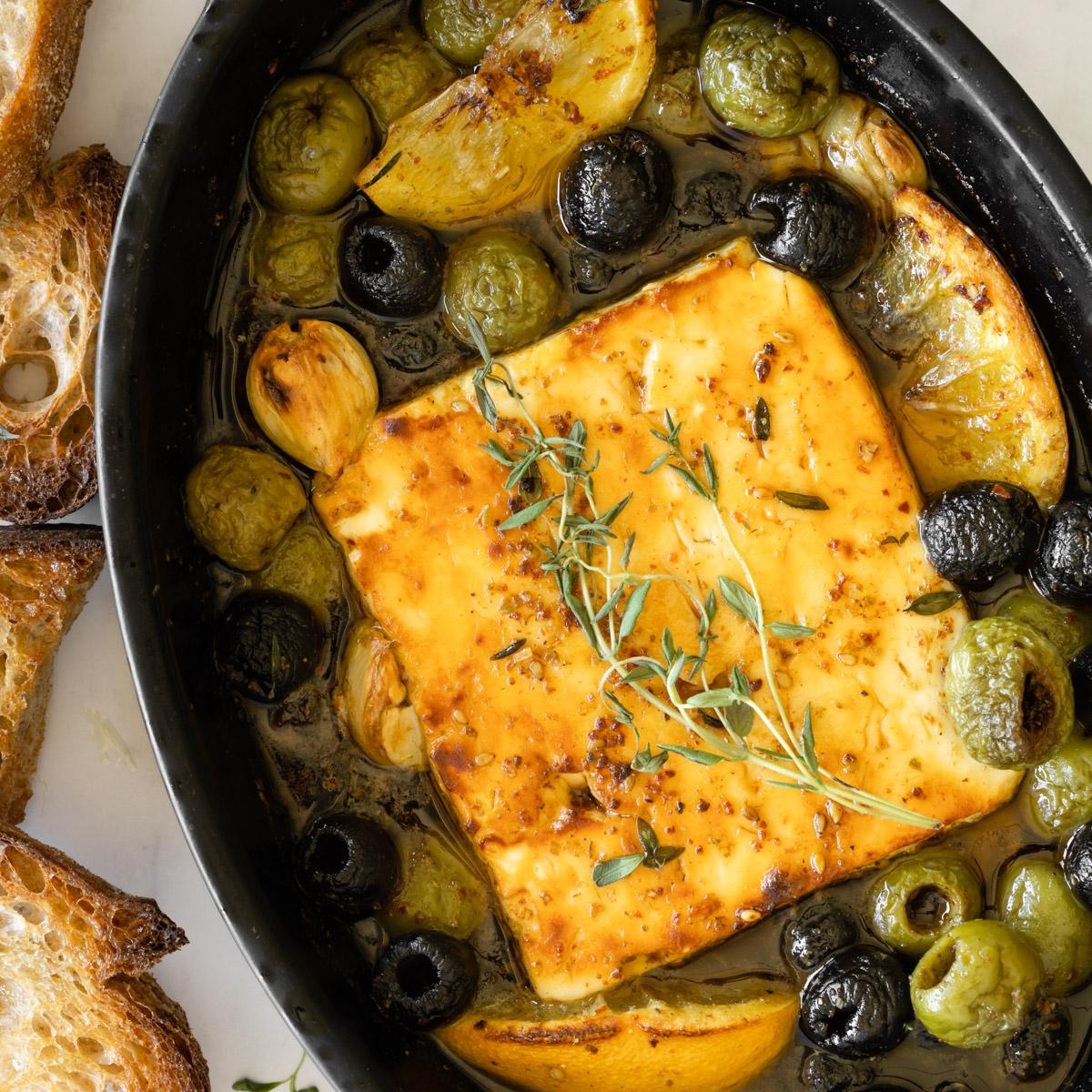 Baked feta cheese, golden brown and bubbly, with a fresh olive oil drizzle