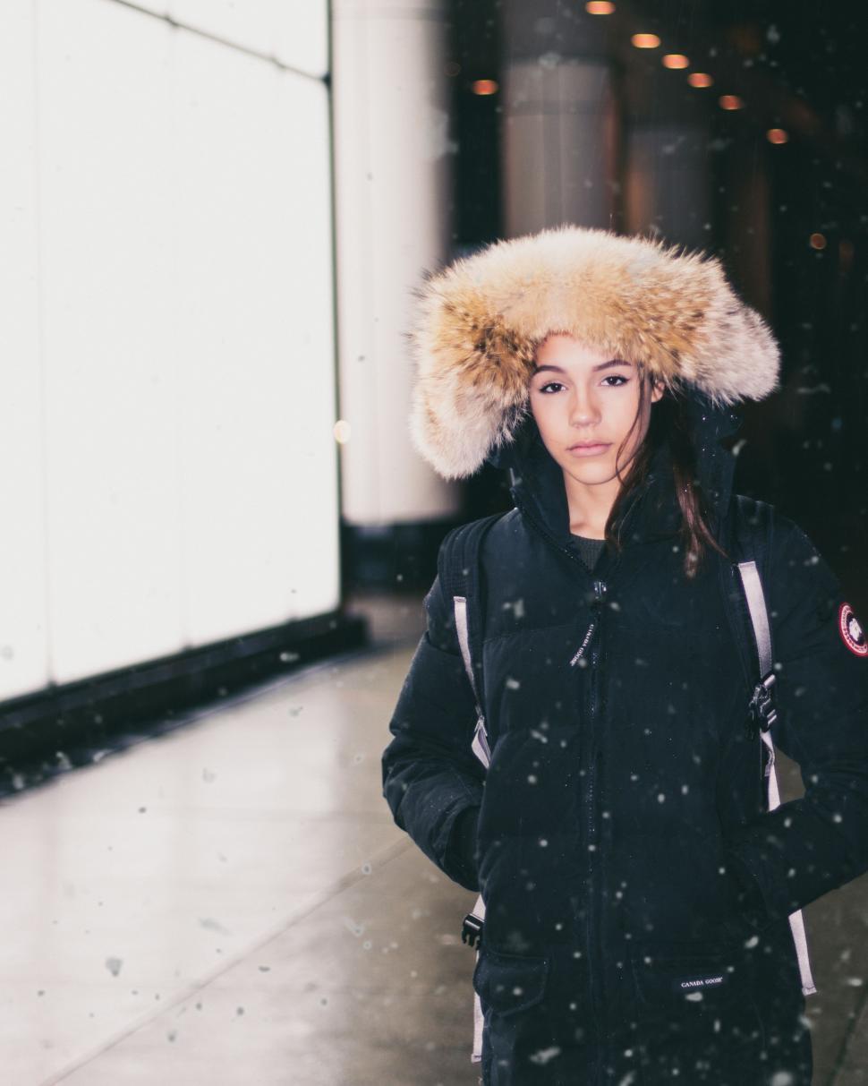 Woman bundled up in winter clothes in a city