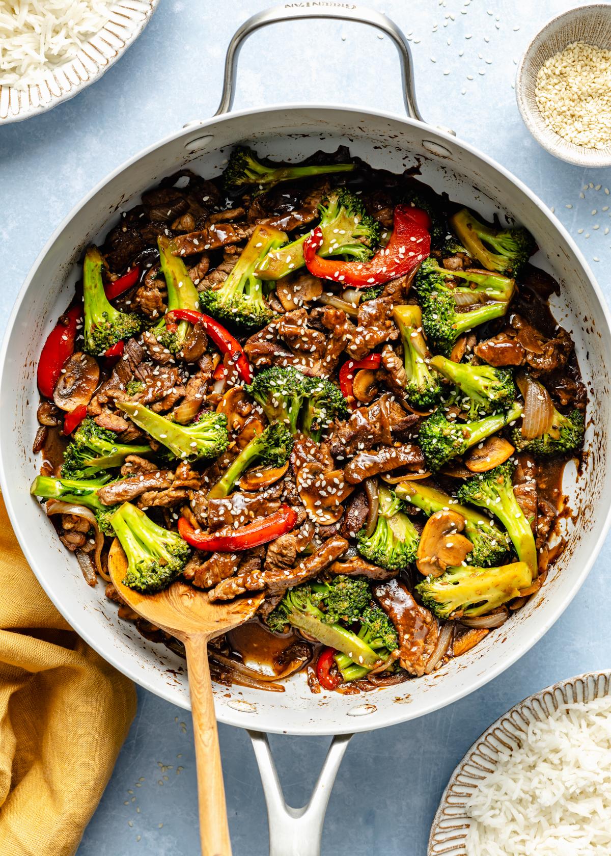 stir-frying chili-glazed beef and broccoli in a pan