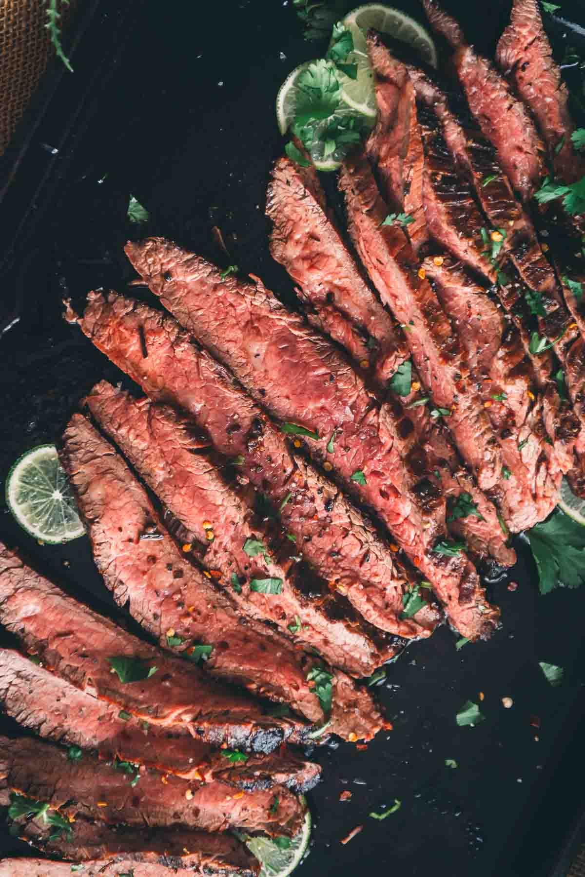 close-up of grilled flank steak being sliced