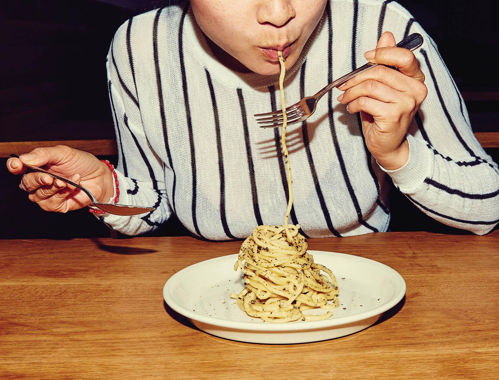 person testing the doneness of gluten-free pasta