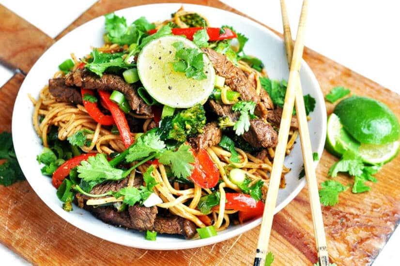 Ingredients for chipotle lime beef stir fry on a wooden board