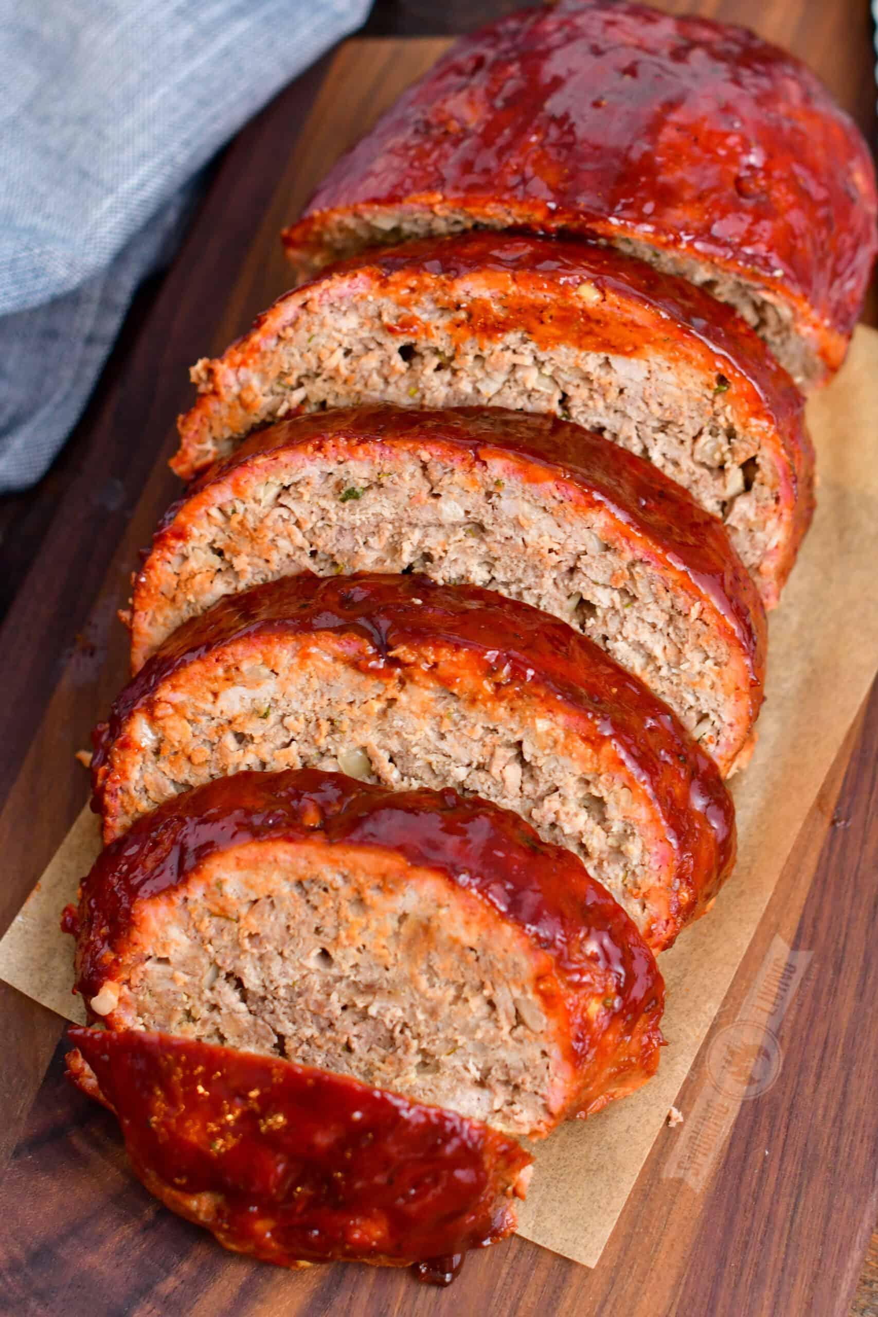 Close-up of freshly baked smoky herb meatloaf, sliced, with steam rising