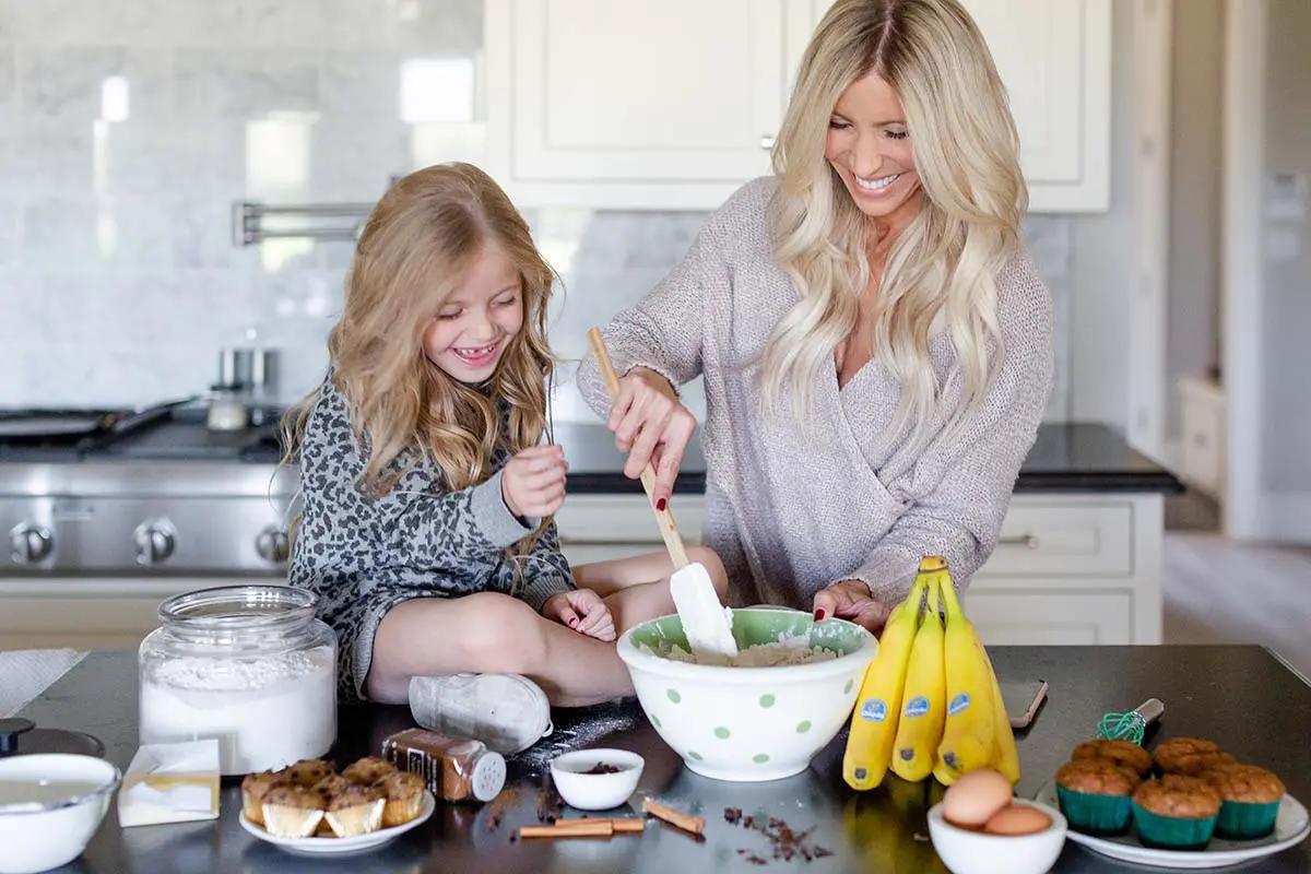 woman happily baking banana bread in a sunny kitchen