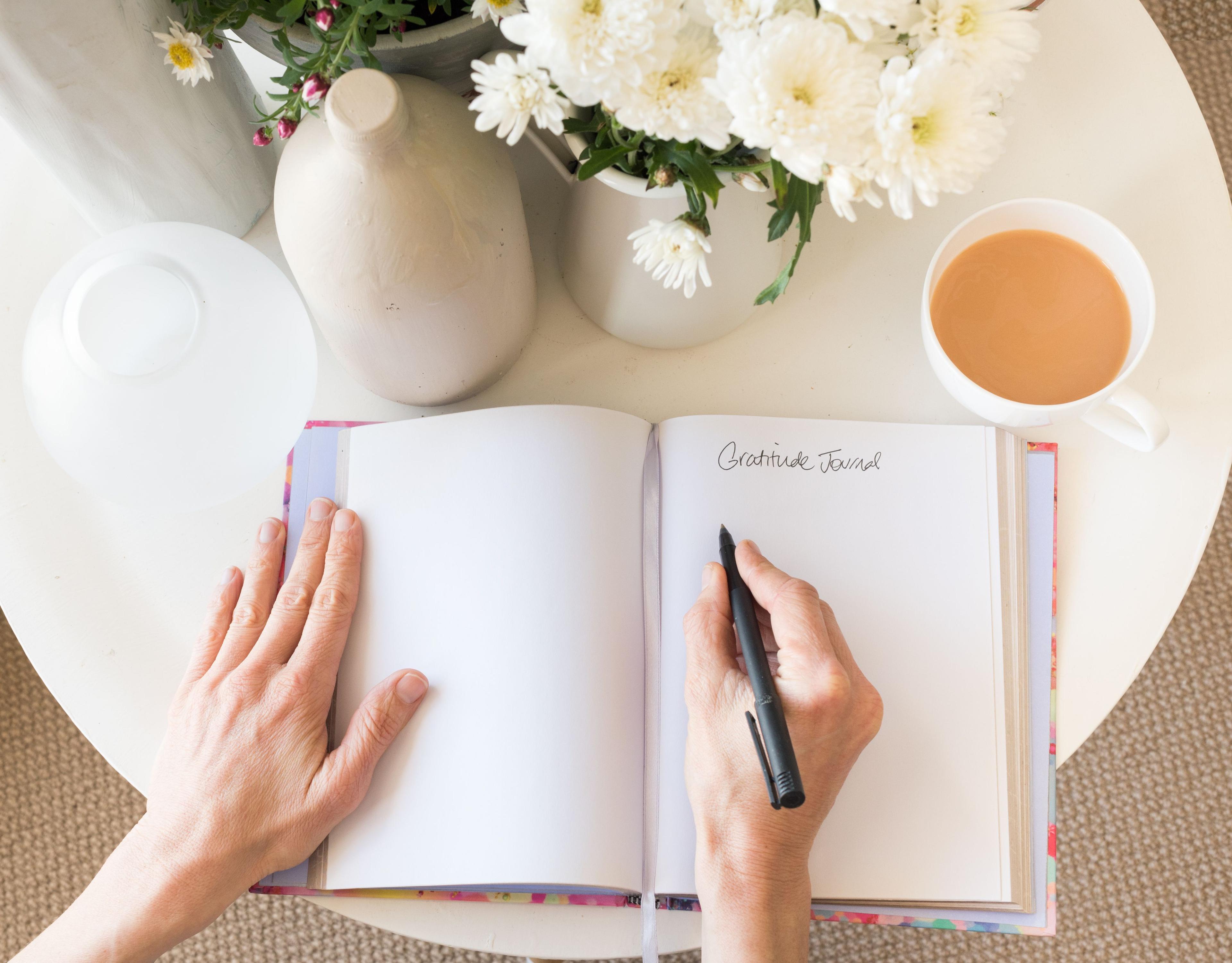 Person writing in a gratitude journal