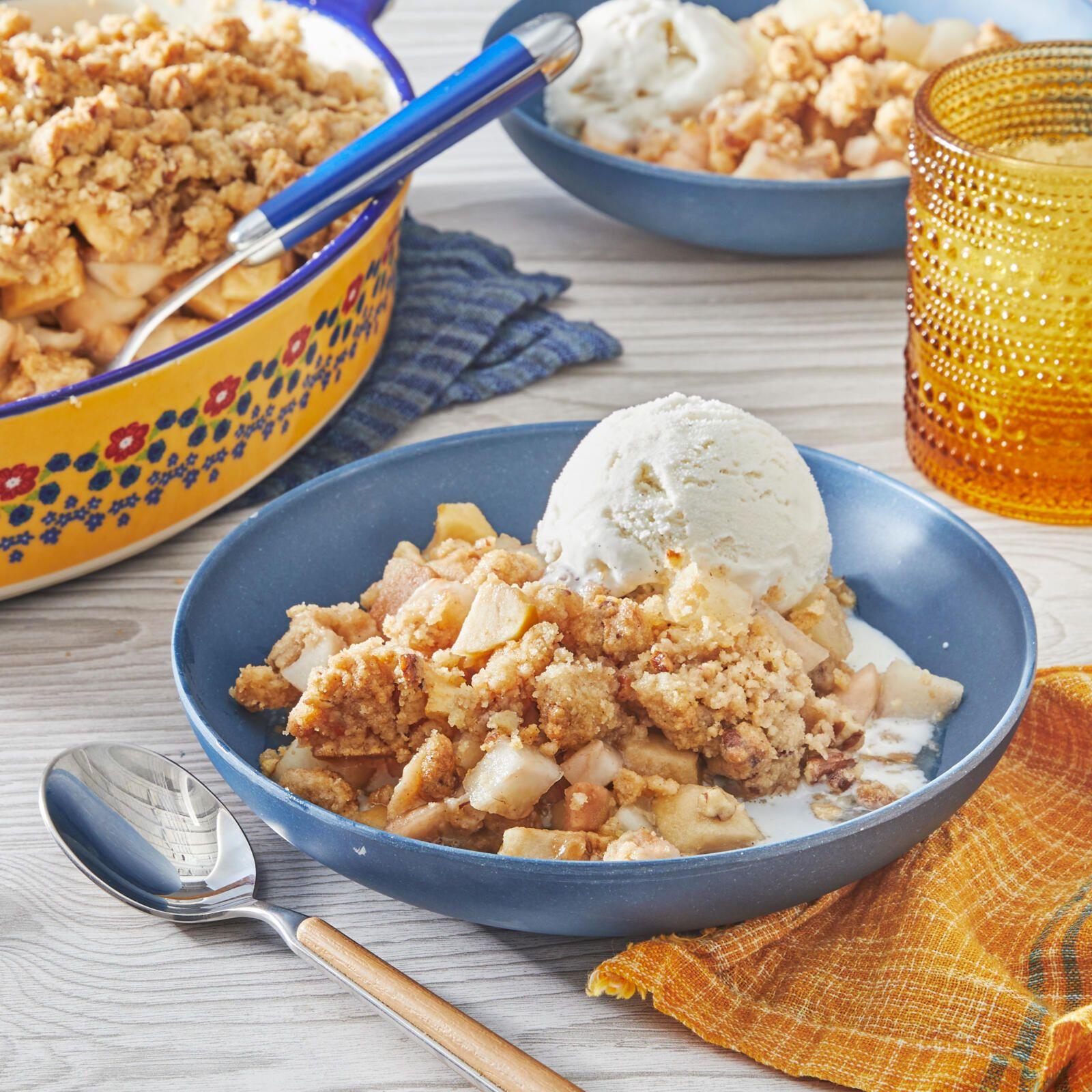 Close-up shot of a spoonful of French Vanilla Pear Crisp with vanilla ice cream
