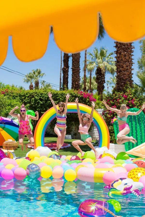 colorful and fun pool party with personalized decorations