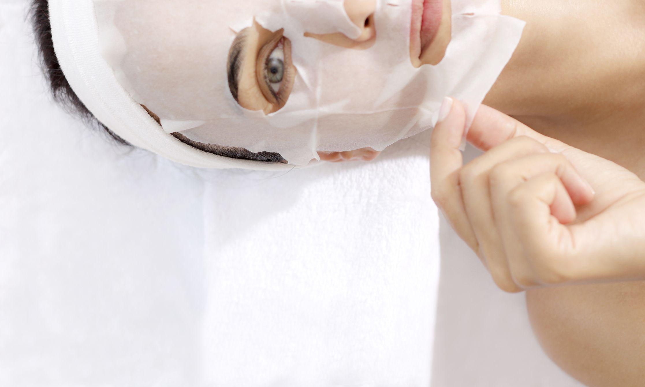 woman using a sheet face mask